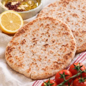 Deliciously Easy Gluten-Free Sourdough Flatbread Recipe 3 Gluten-Free Sourdough Flatbread displayed with fresh veggies and sauces.