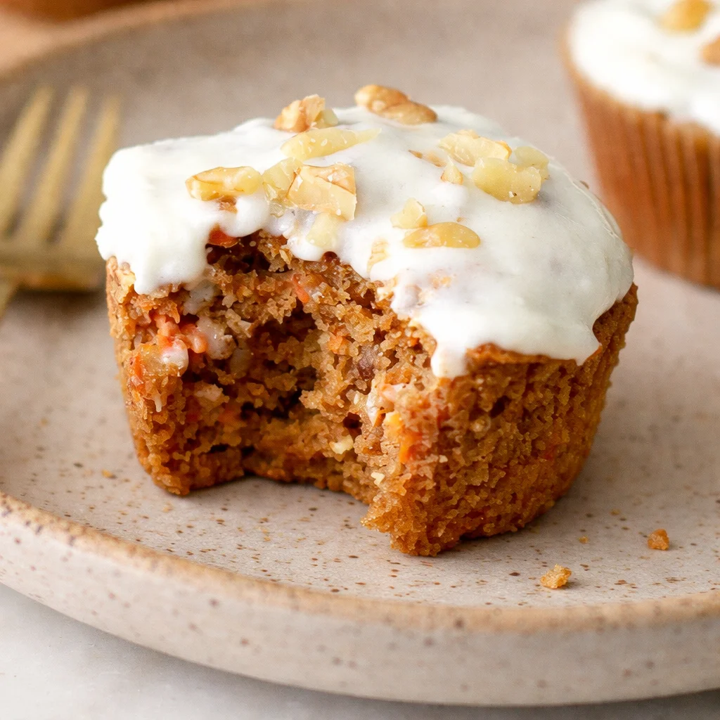 Deliciously moist and fluffy gluten-free carrot muffins topped with warm spices.